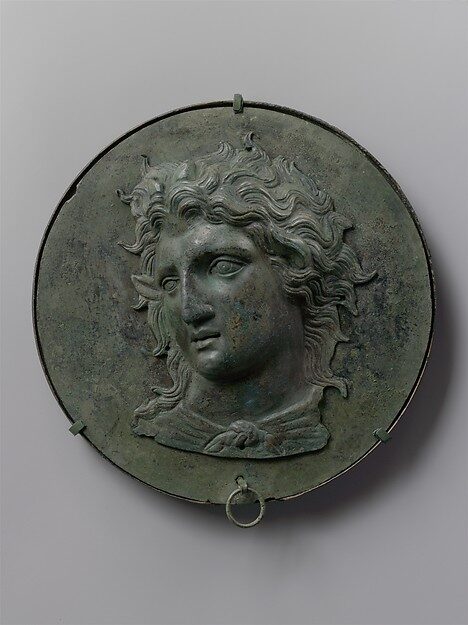 Greek bronze box-mirror with a relief head of Pan, late 4th century BCE.