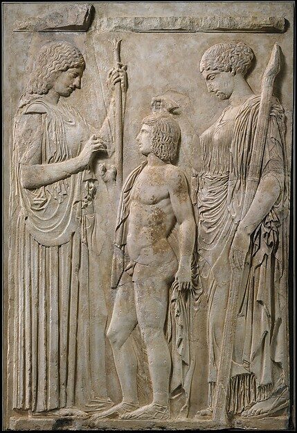 The Great Eleusinian Relief: Demeter and Persephone (right, with torch) flanking the youth Triptolemos, Roman copy ca. 27 BCE–14 CE.